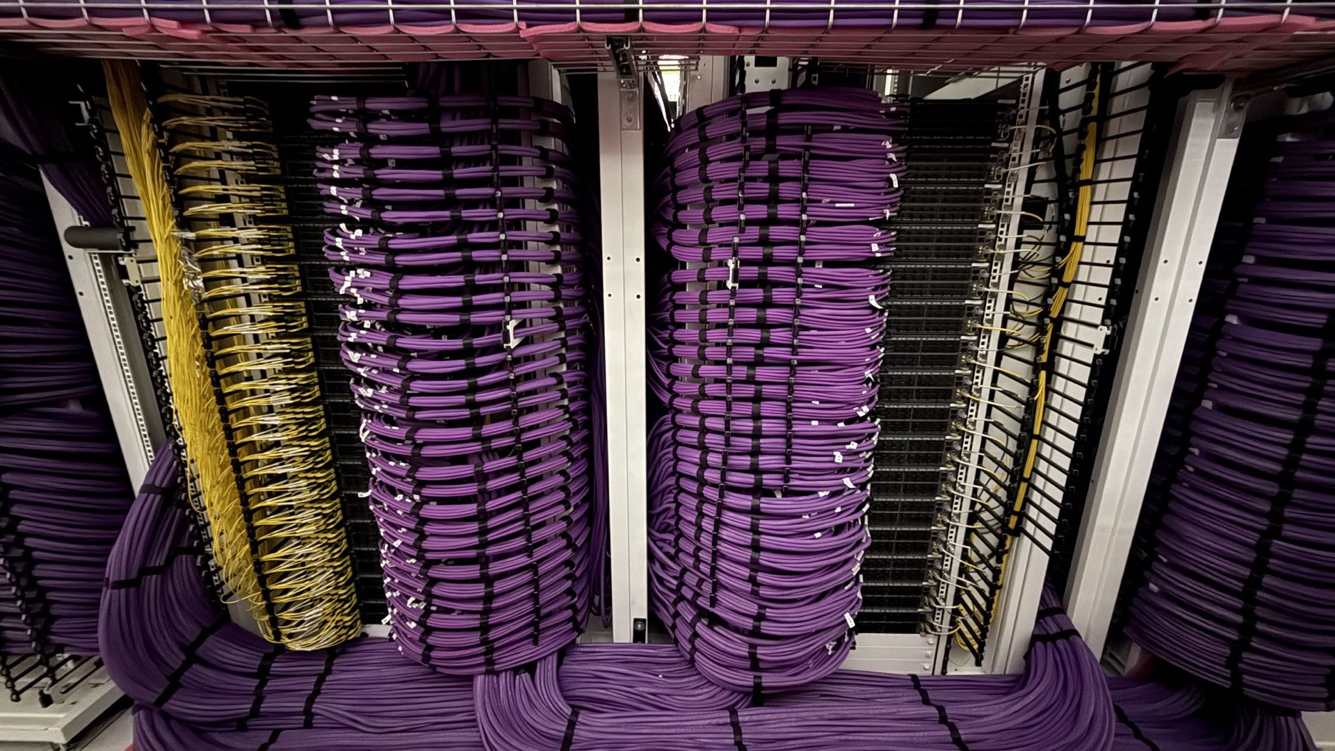 colossus-1920x1080 | TeslaNorth.com Colossus 2 GPU racks with dense purple and yellow cabling