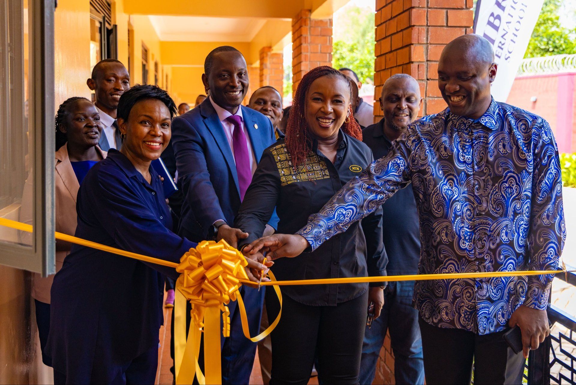 MTN Uganda CEO Sylvia Mulinge cuts a yellow ribbon with guests at Libra International School to launch MTN Starlink for Business.