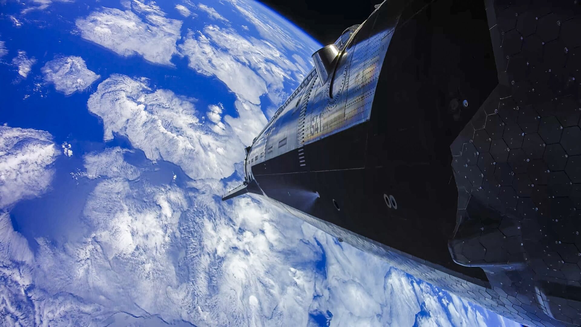 A horizon of Earth seen from space with a metallic spacecraft module in the foreground.