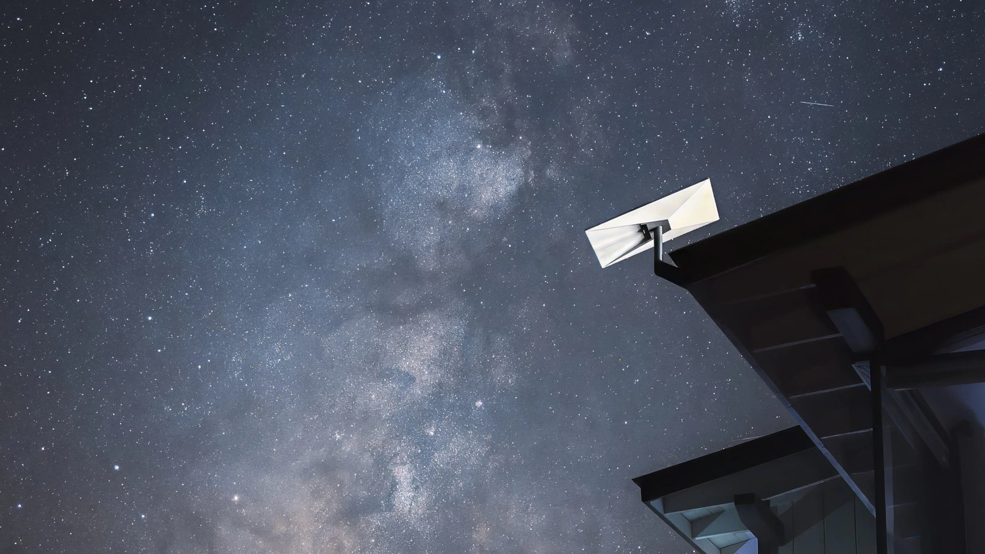 A Starlink dish under the night sky