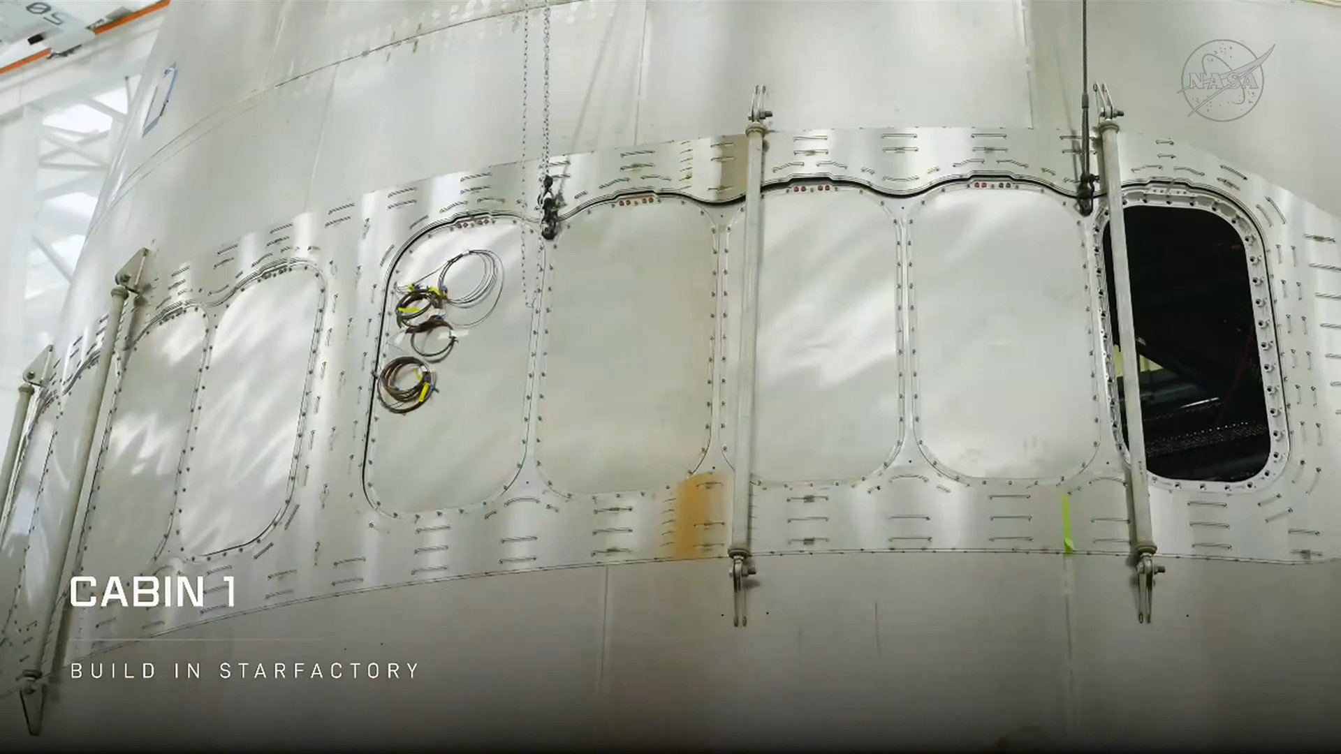 starship-cabin-1-windows-starfactory | TeslaNorth.com Starship Cabin 1 steel hull section with window openings inside SpaceX Starfactory