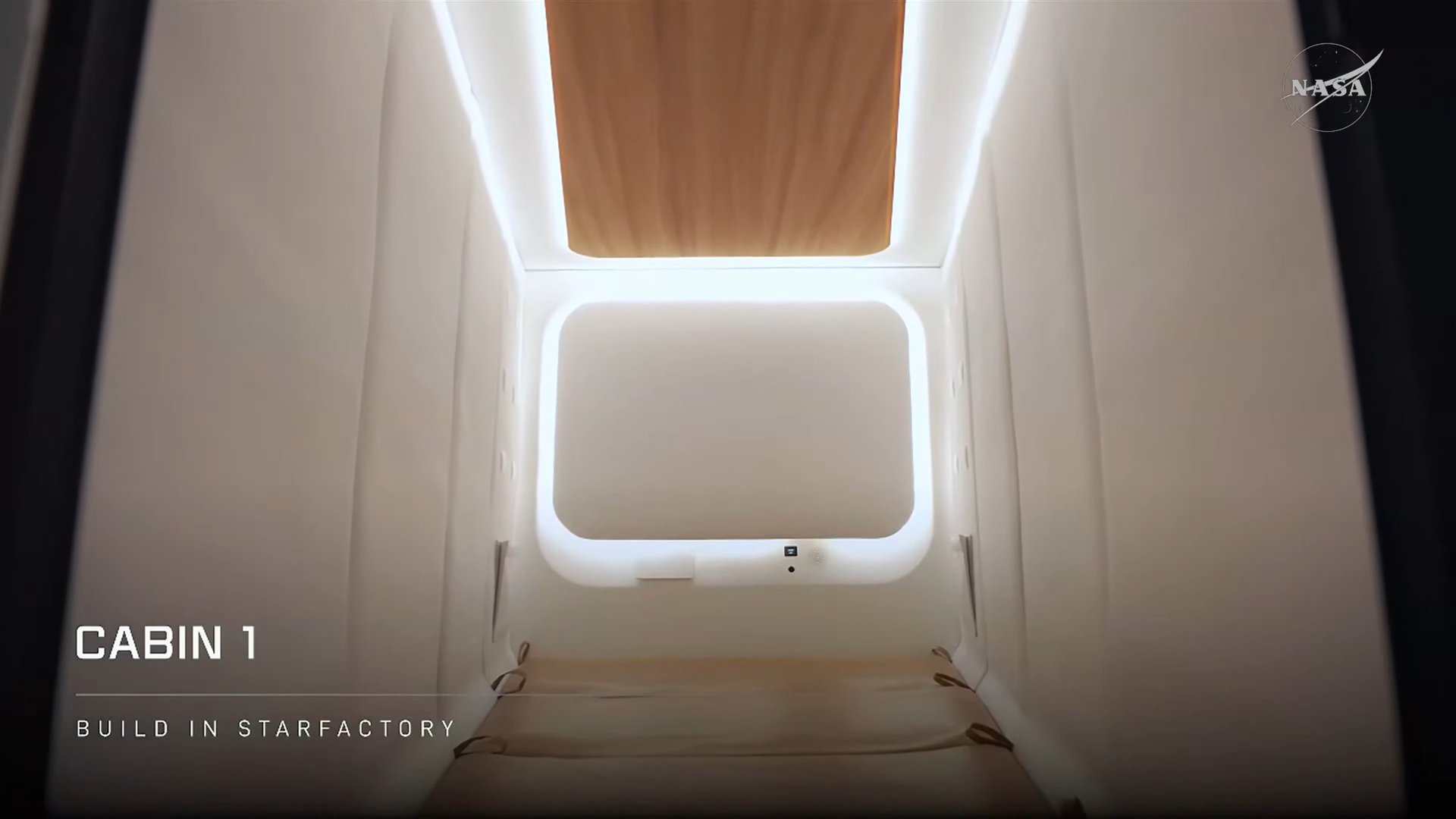 Interior of SpaceX Starship moon lander Cabin 1 with padded white walls and lit ceiling panel