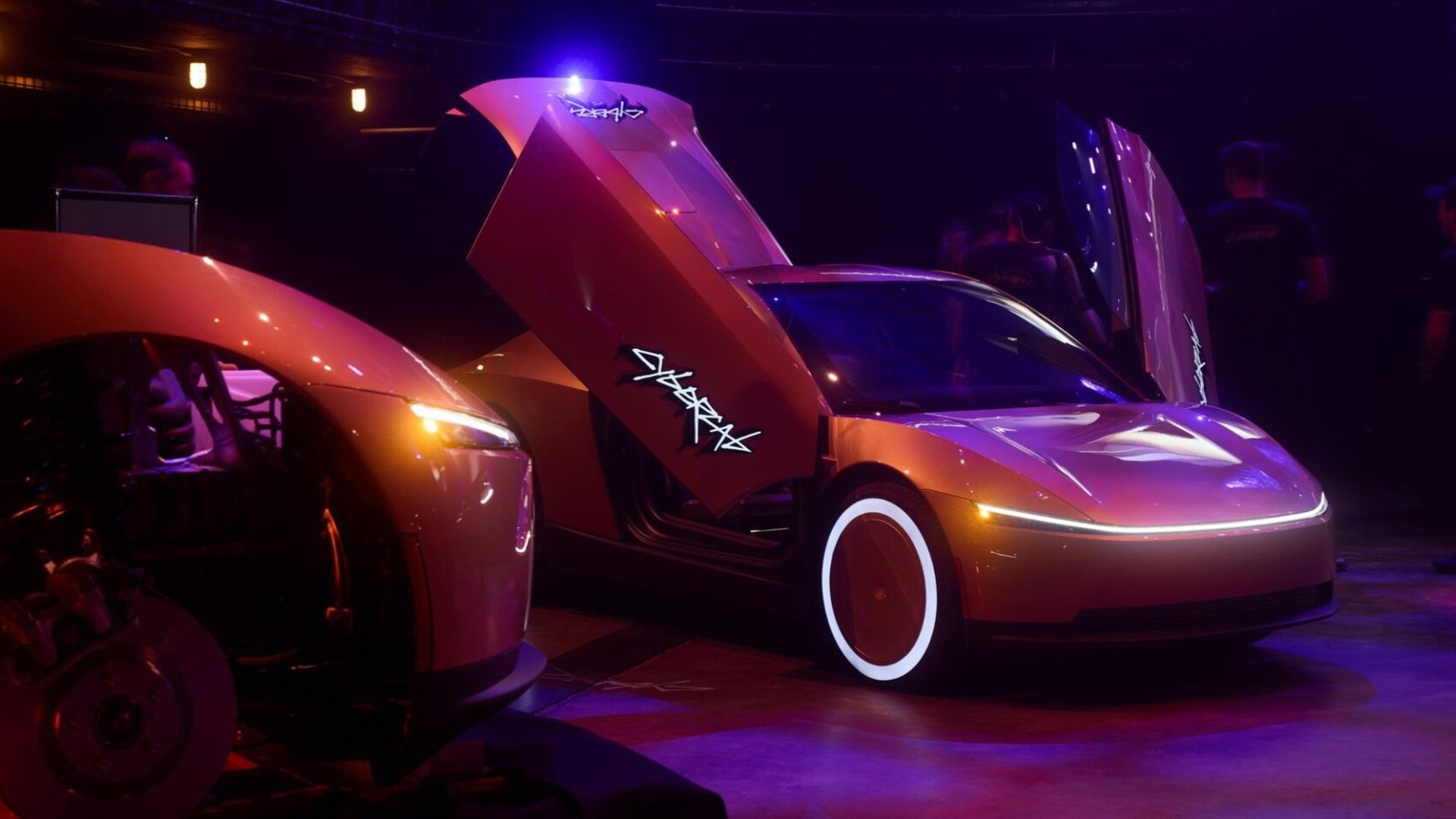 Orange futuristic sports car with its scissor doors open, showcased in a dim, neon-lit showroom.