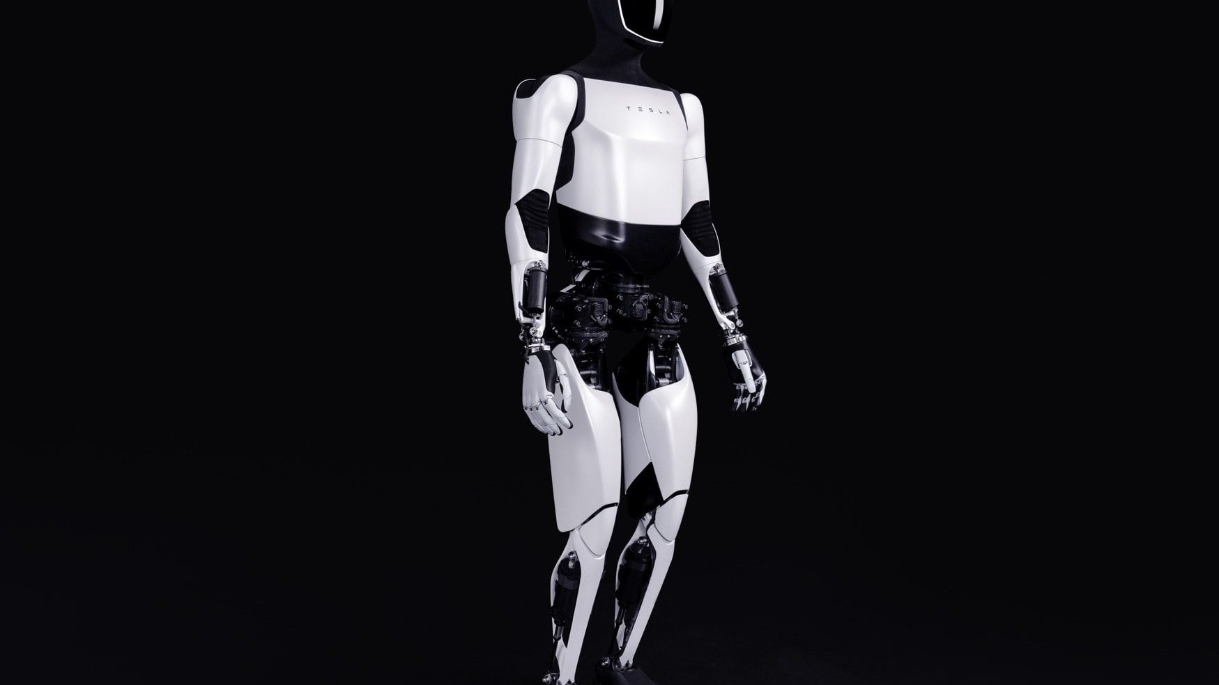 Tesla humanoid robot standing upright against a dark background in a studio setting.