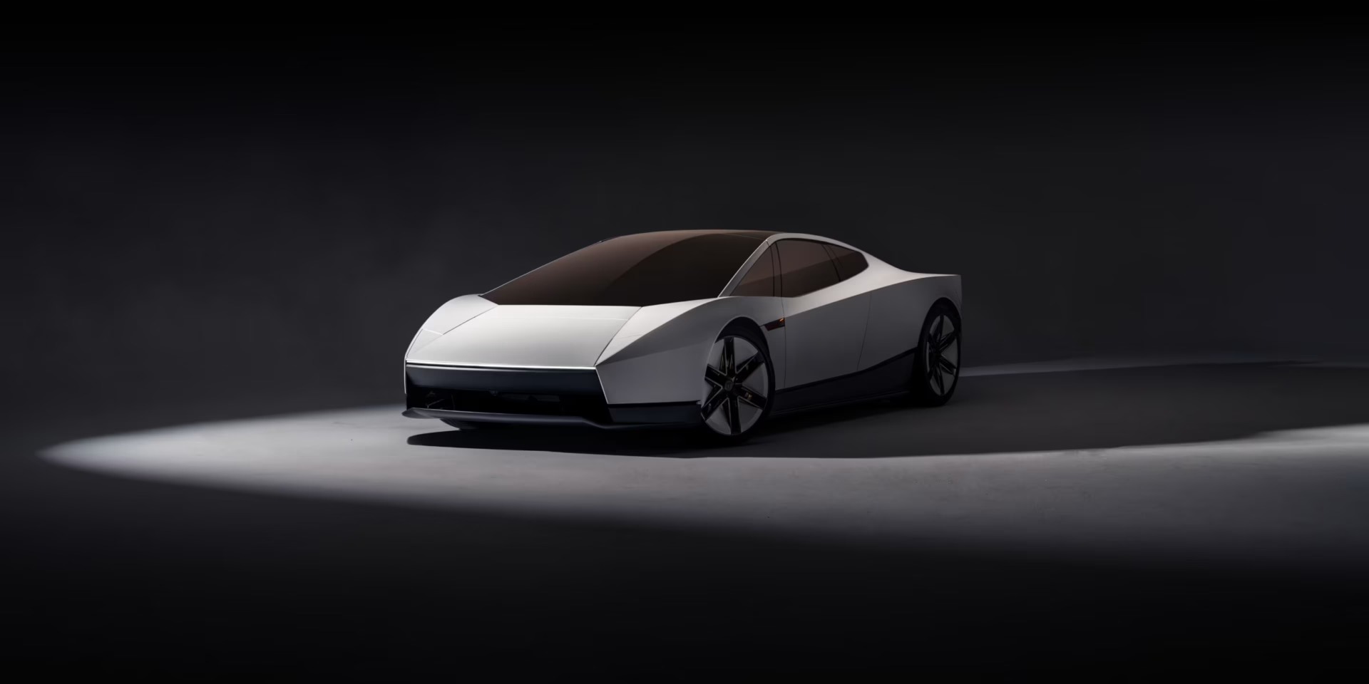 A white next-generation Tesla Roadster under a spotlight in a dark studio