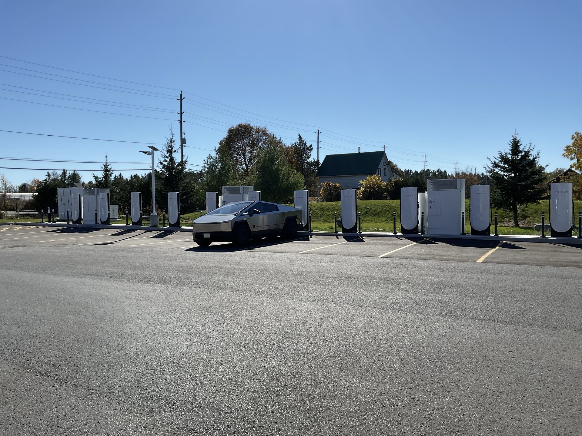 Cybertruck charging at Tesla's new 12-stall Supercharger on Highway 15 in Kingston, Ontario